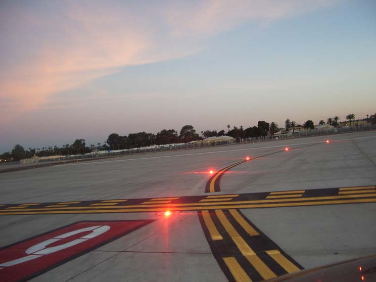 A picture of runway entrance lights at an airport.