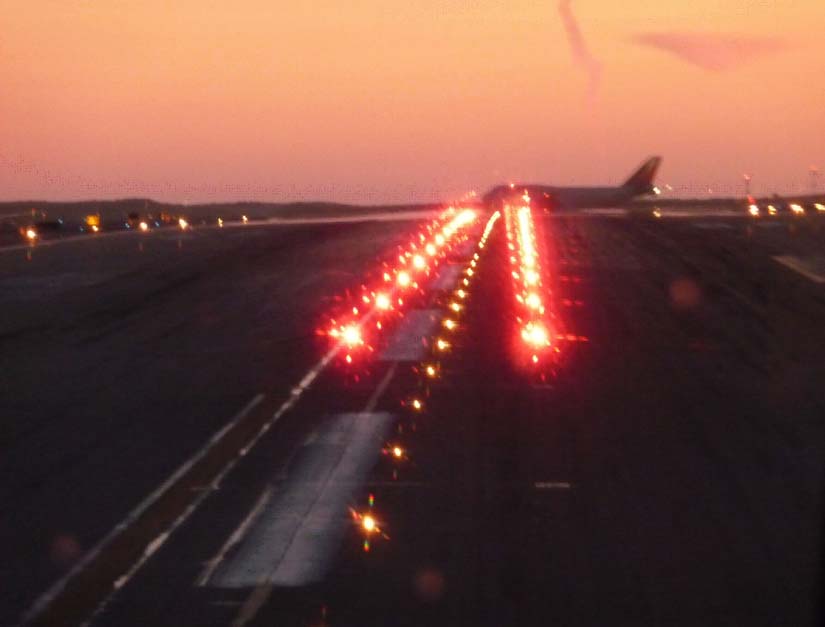 A picture of takeoff hold lights at an airport.