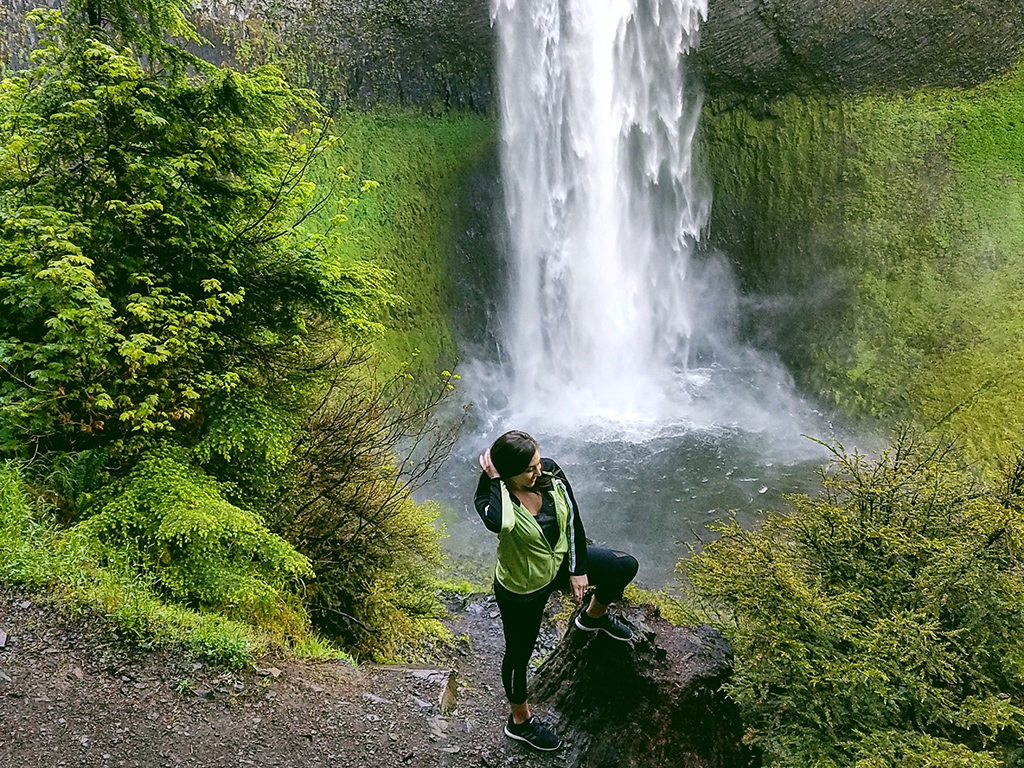 Braylee standing in front of a waterfall.