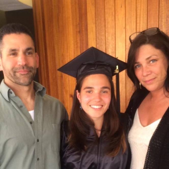 Jeanette Elia in her graduation gown with her family